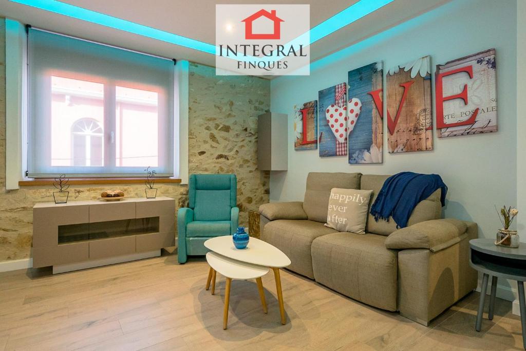 a living room with a couch and a table at Palamós Luxe Apartments in Palamós
