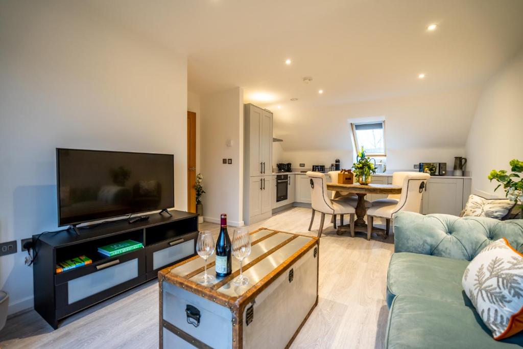 a living room with a couch and a flat screen tv at 28 St John's Mews in York
