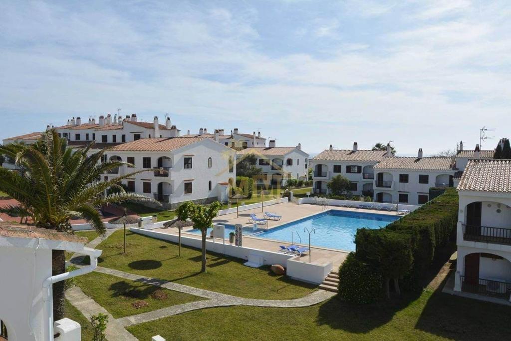 a view of a villa with a swimming pool at Apartamento Can escaragoli in Cala en Porter