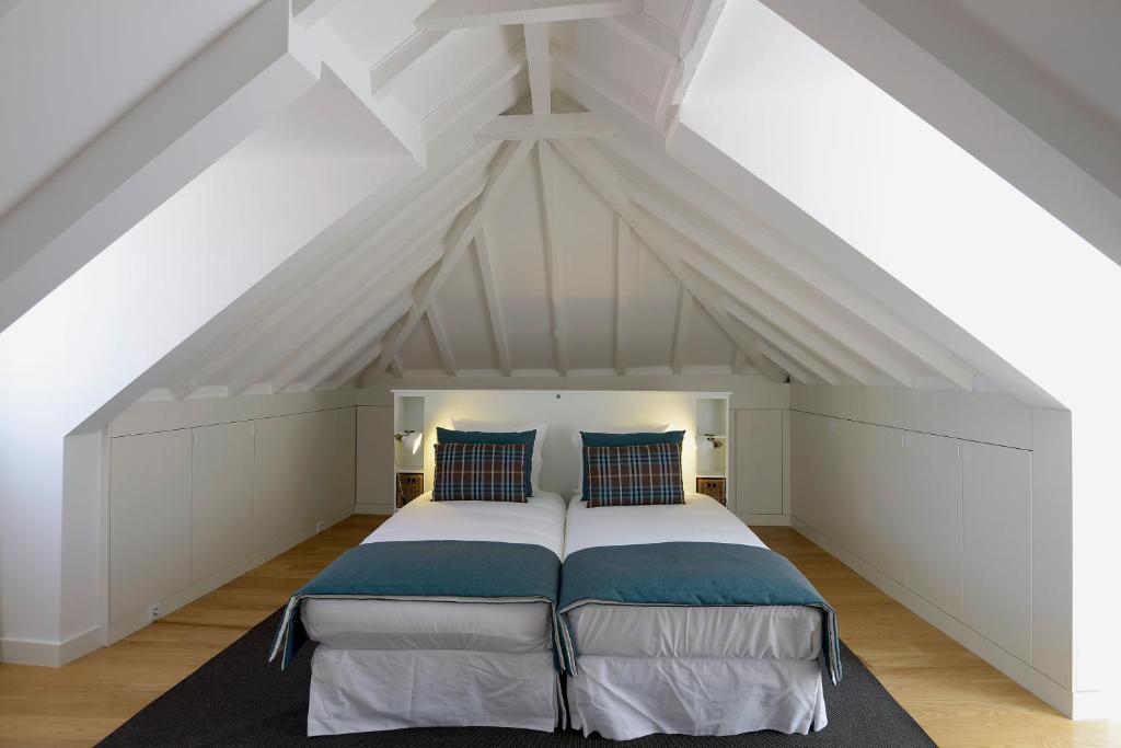 a bedroom with a large bed in the attic at FLH Luxus Santa Catarina in Lisbon