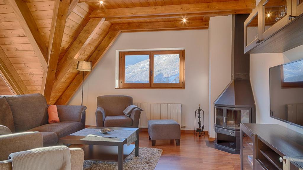 a living room with a couch and a fireplace at Saplan Real Estate SAUBAGA in Bossòst