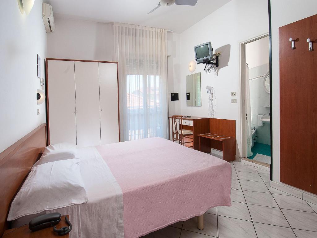 Postel nebo postele na pokoji v ubytování Hotel Odeon
