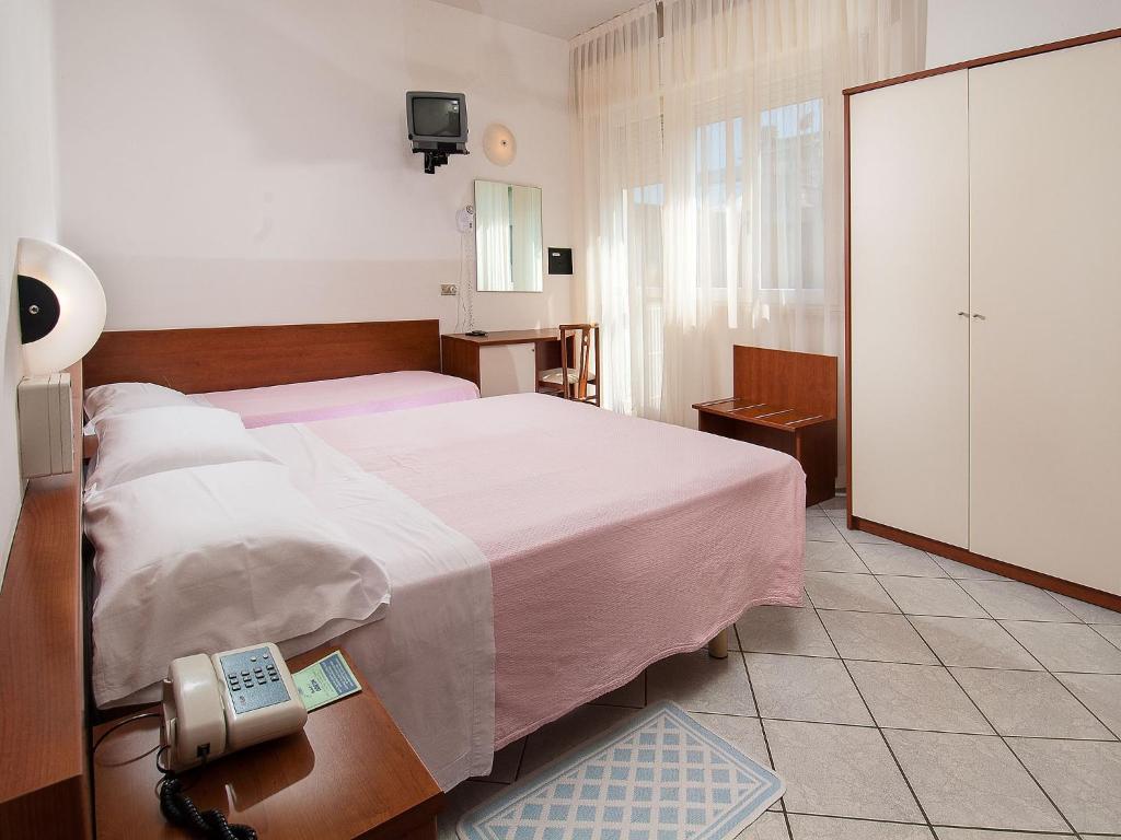 Postel nebo postele na pokoji v ubytování Hotel Odeon