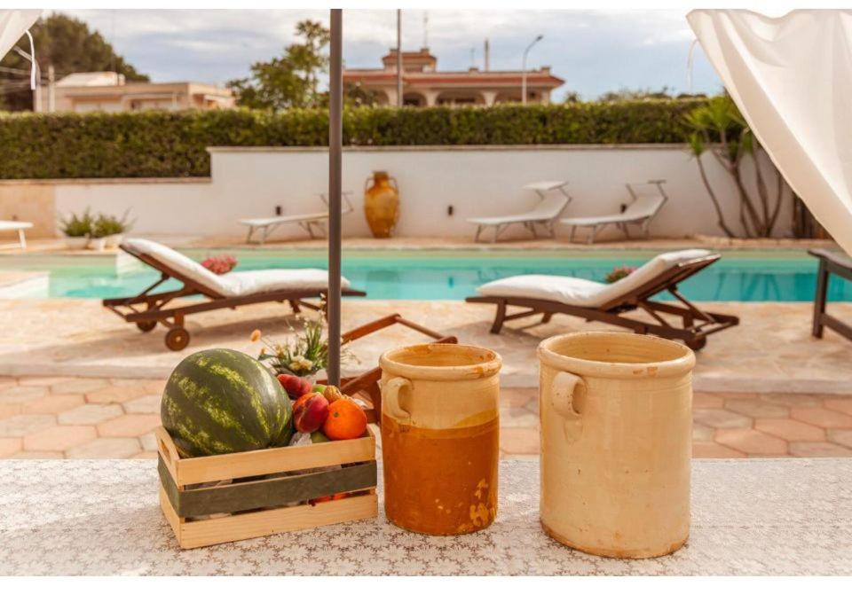 un tavolo con un cesto di frutta e un vassoio di anguria di Casa de lidzia2 a Cisternino