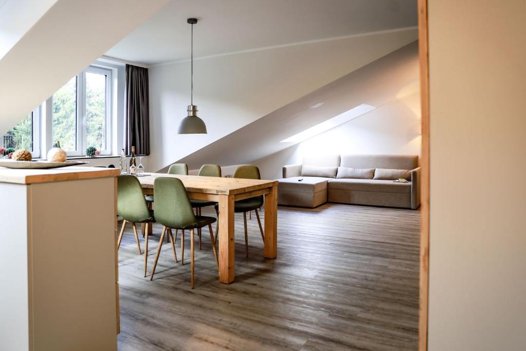 a kitchen and living room with a table and chairs at Smart Resorts Haus Azur Ferienwohnung 812 in Winterberg