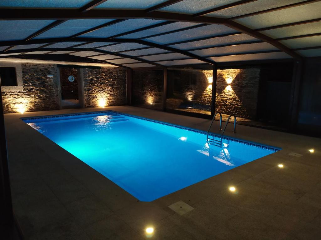 a large swimming pool in a building with a ceiling at Casa Bama in Bama