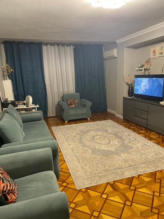 a living room with a couch and a tv at 2-х комнатная квартира in Pizunda