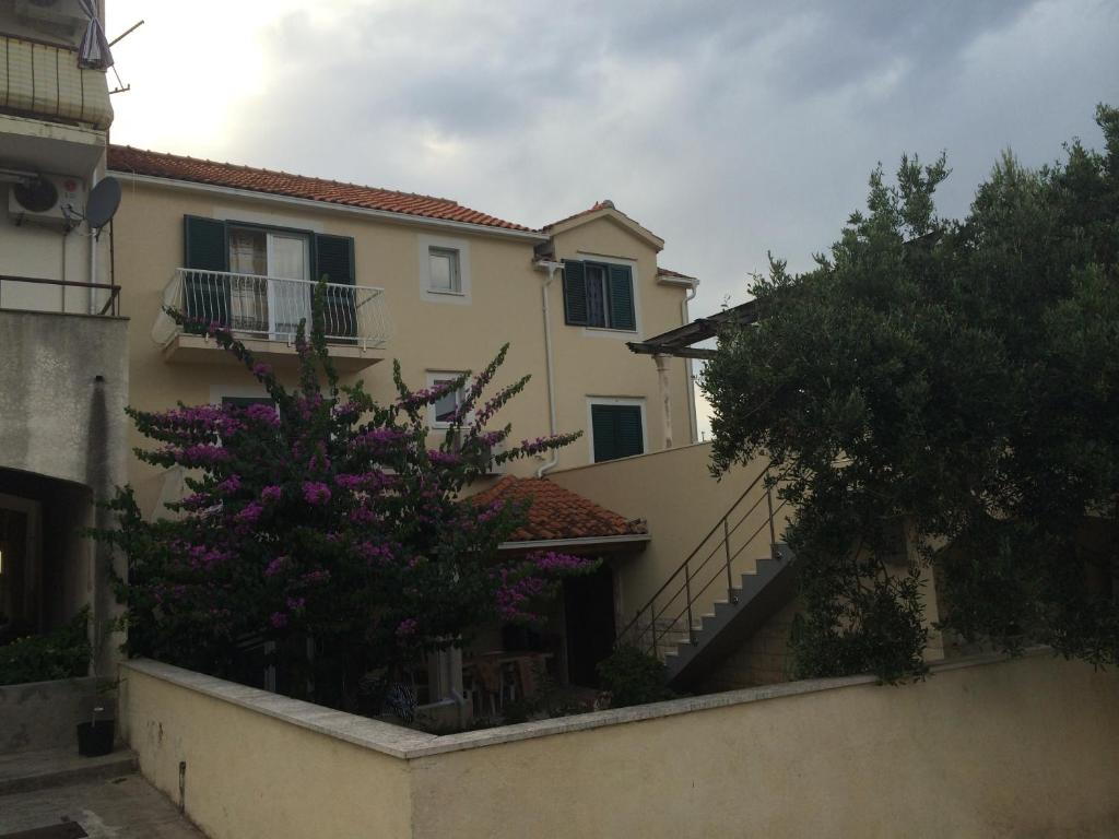 a house with purple flowers in front of it at Apartment Vesna in Supetar
