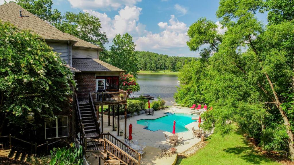 an aerial view of a house with a swimming pool at Bama Lakeside Retreat in Tuscaloosa