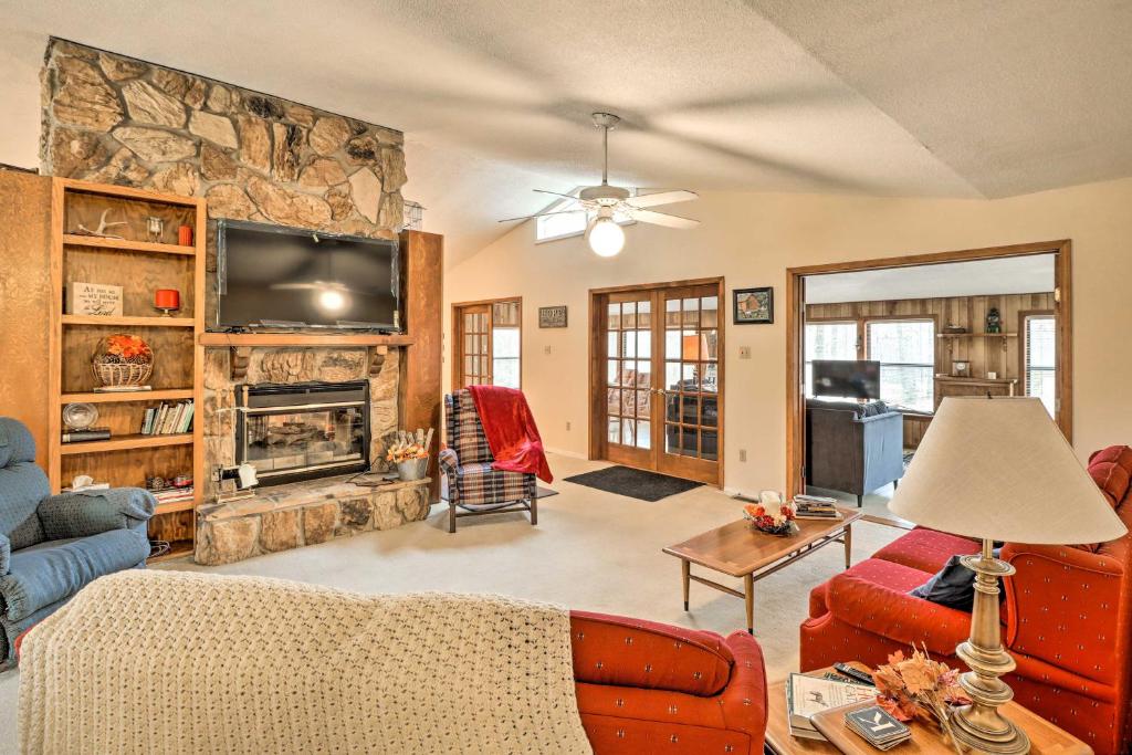 a living room with a fireplace and a tv at 40-Acre Poplar Bluff Nature Lovers Paradise! in Poplar Bluff