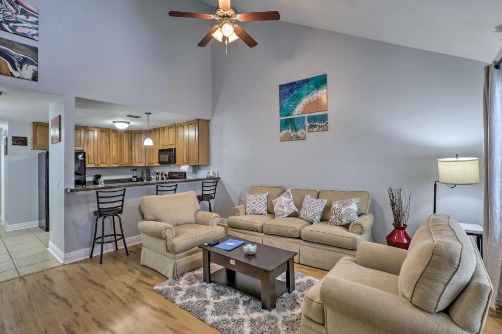 a living room with two couches and a kitchen at Tidy Tallahassee Townhome about 7 Mi to Downtown! in Tallahassee