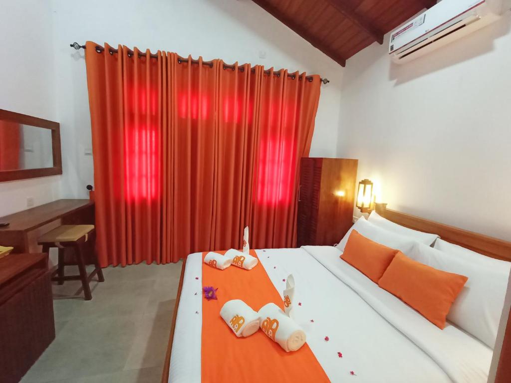 Postel nebo postele na pokoji v ubytování Three Elephant Holiday Inn
