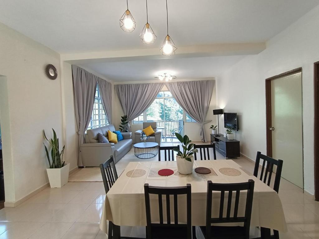a dining room and living room with a table and chairs at Dream 2 in Cameron Highlands