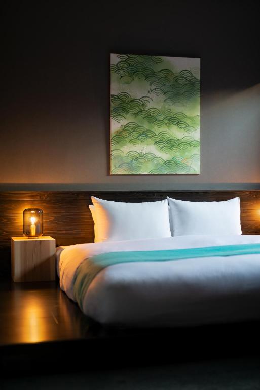 Postel nebo postele na pokoji v ubytování THE MACHIYA HOTEL TAKAYAMA