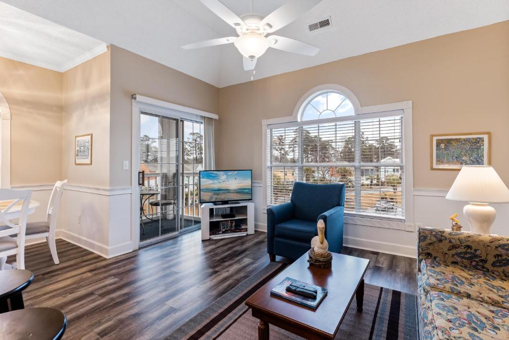 a living room with a couch and a tv at Myrtle Beach Getaway 1 in Myrtle Beach