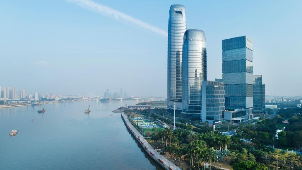 a city with tall buildings next to a river at InterContinental Guangzhou Exhibition Center, an IHG Hotel - Free Canton Fair Shuttle Bus and Registration Counter in Guangzhou