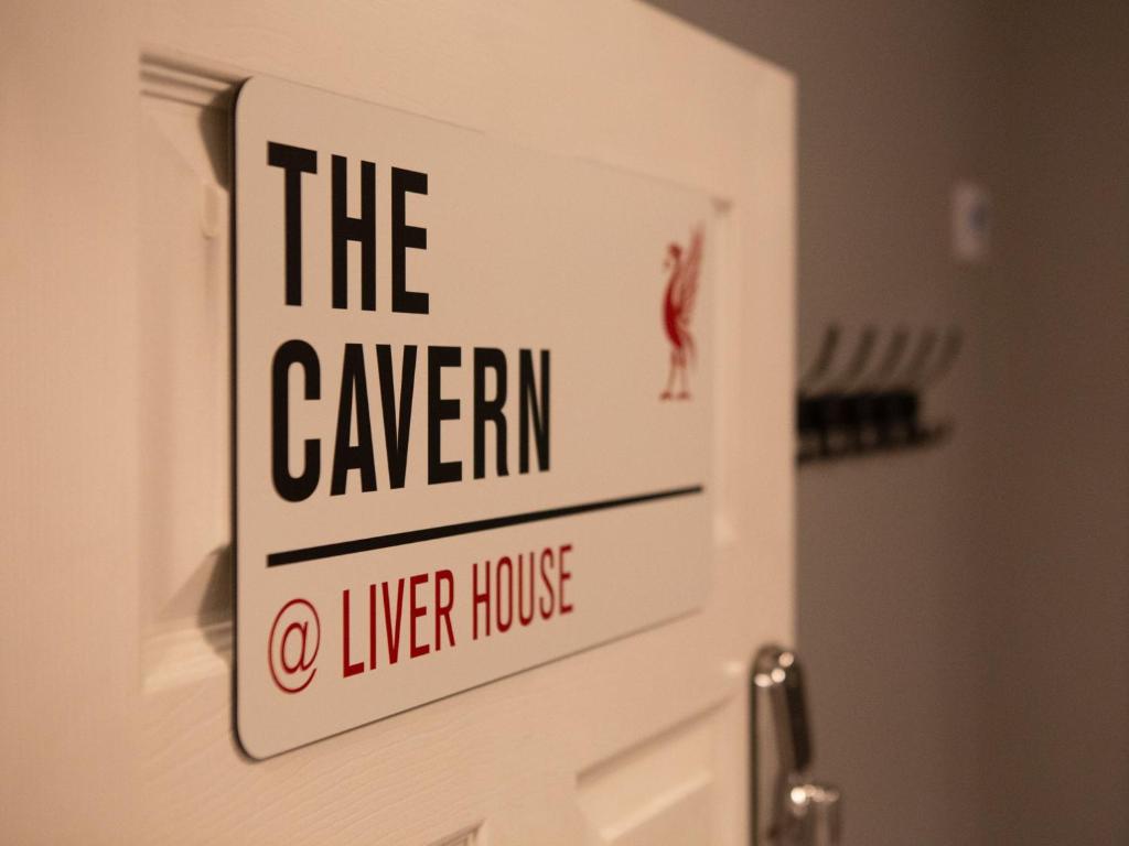 a sign on a door that reads the tavern at The Cavern Apartment @ Liver House in Rock Ferry