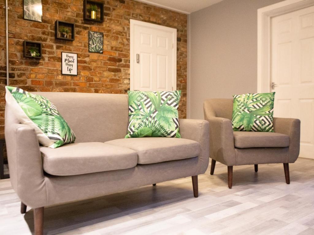 a living room with a couch and two chairs at The Mersey Apartment @ Liver House in Rock Ferry