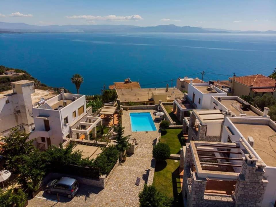 an aerial view of a house with a swimming pool at Malvazios Villas #8 in Mavrovoúnion