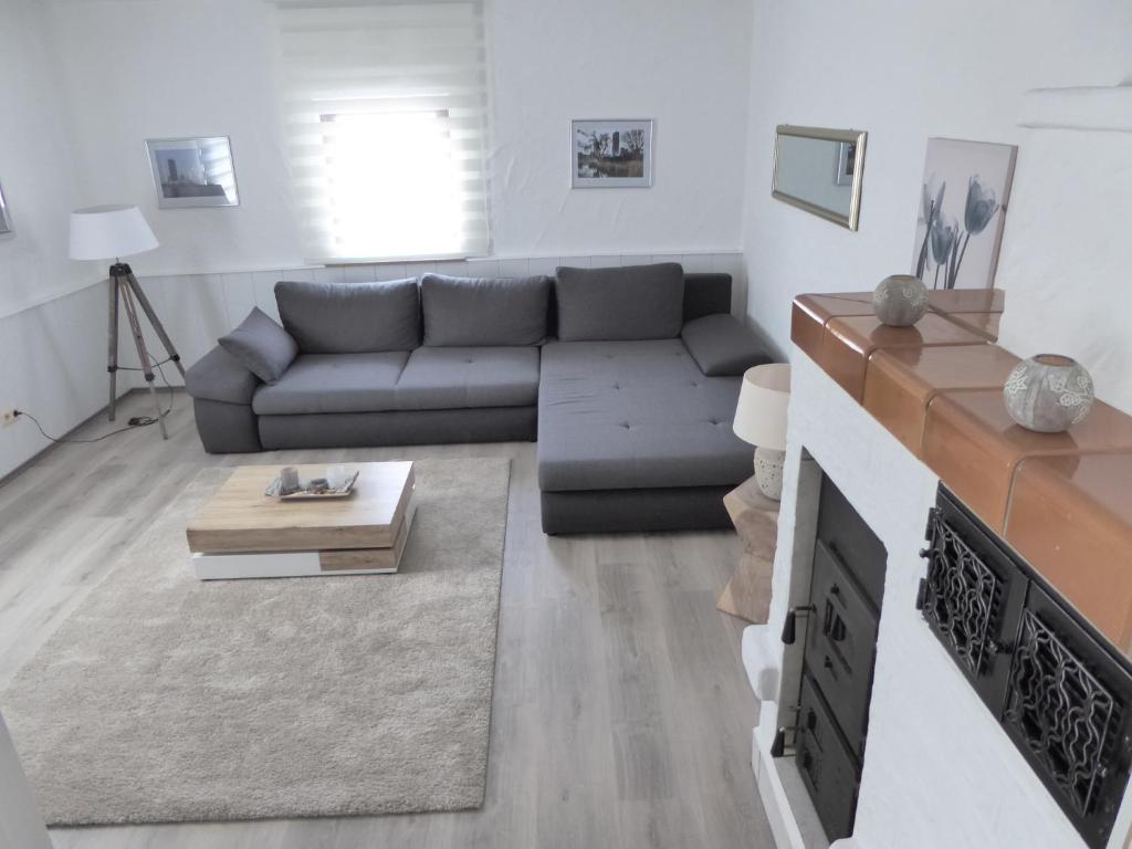 a living room with a couch and a fireplace at Ambiente Ferienapartments Julienhöhe in Niederdorf
