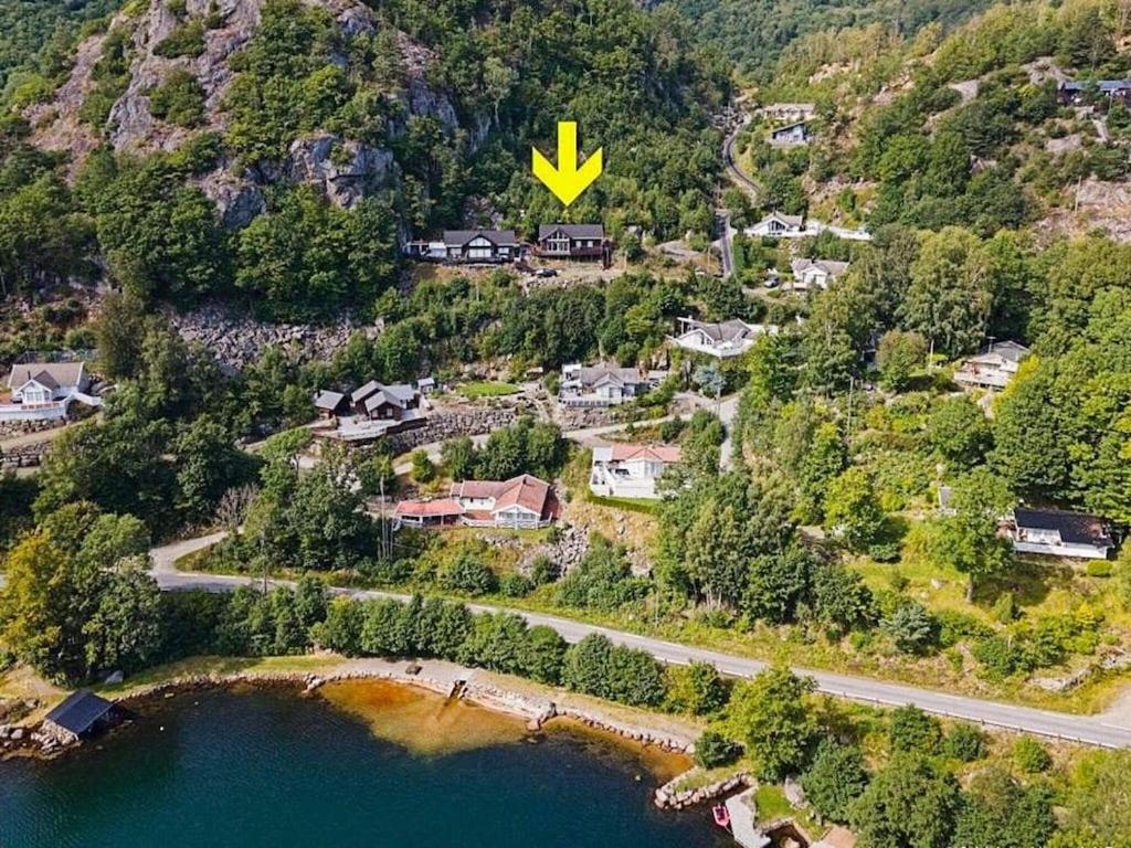 una vista aérea de un pueblo con una carretera y un lago en 10 person holiday home in lyngdal, en Lyngdal
