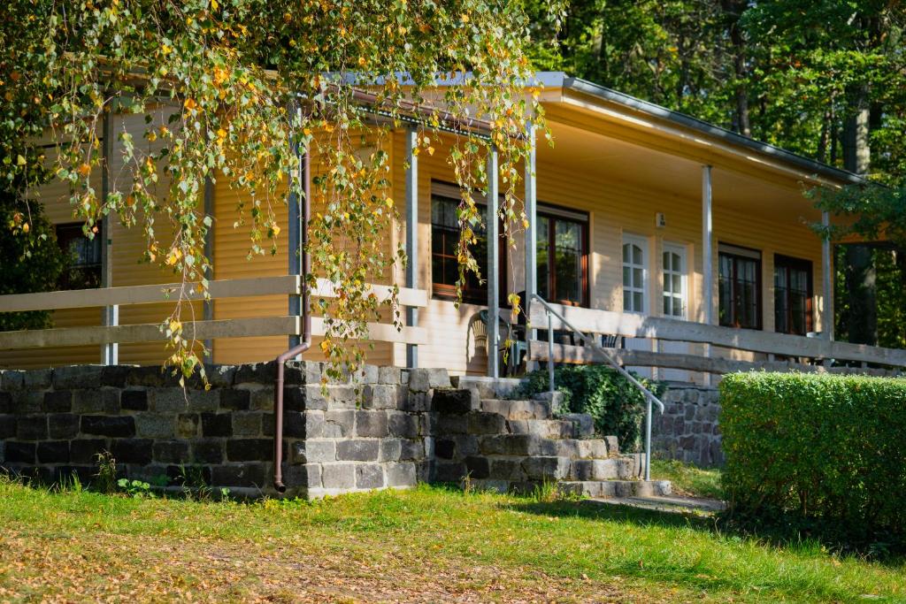 uma casa amarela com escadas em frente em Ferienpark Bad Sonnenland em Moritzburg