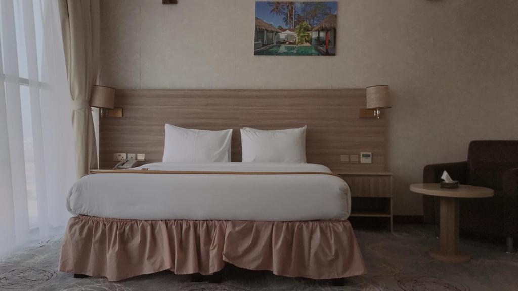 Postel nebo postele na pokoji v ubytování Grand Tourist Hotel