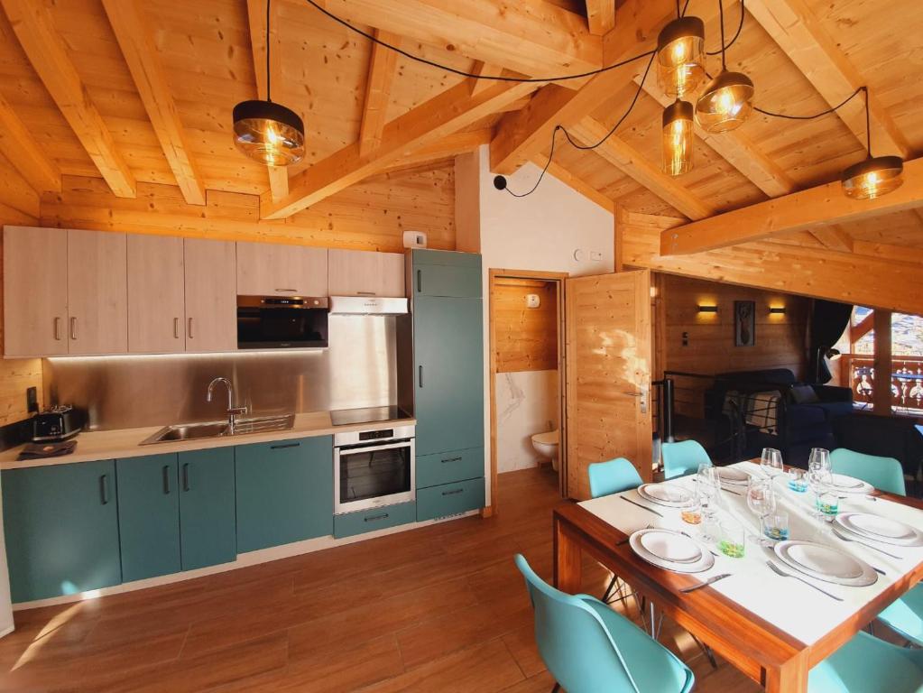 a kitchen and dining room with a table and chairs at Chalet Delphinette - Spa privatif in Morzine