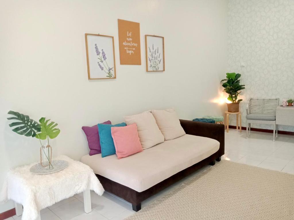 ポートディクソンにあるThe Serene Homestay, Port Dicksonのリビングルーム(カラフルな枕とソファ付)