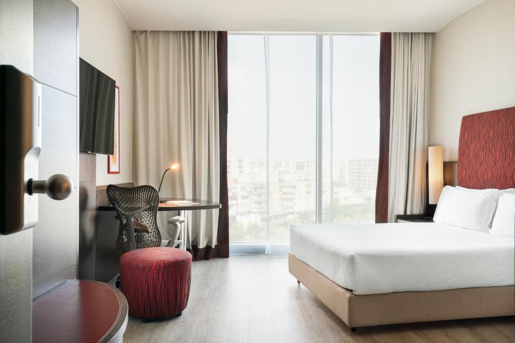 una camera d'albergo con letto, scrivania e finestra di Hi Hotel Bari a Bari