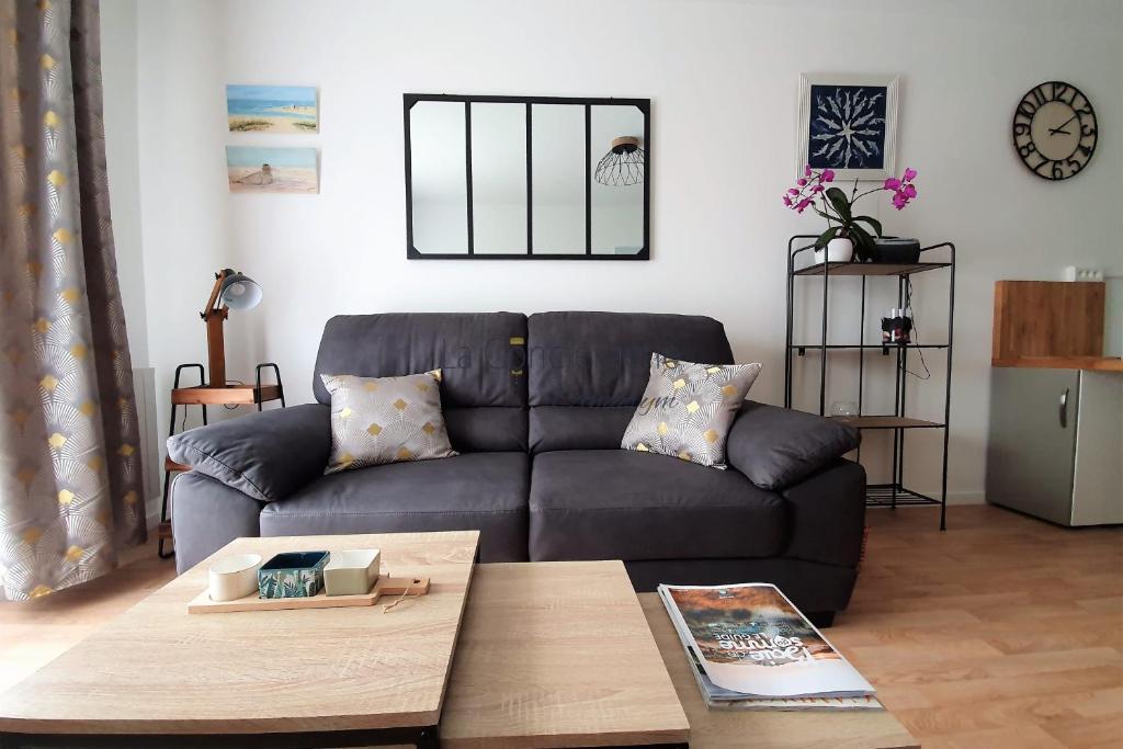 a living room with a couch and a coffee table at A 2 PAS du PORT in Saint-Valéry-sur-Somme