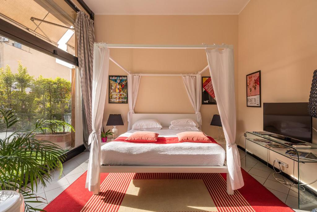 a bedroom with a bed with a canopy at Snob Luxury Suite in Cagliari