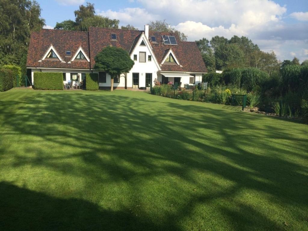 a large house with a large green yard at Ferienwohnung Mittelbach - Whg im OG in Dierhagen