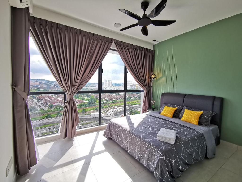 a bedroom with a bed and a large window at Astetica Residences 100mbps Wifi Netflix in Seri Kembangan