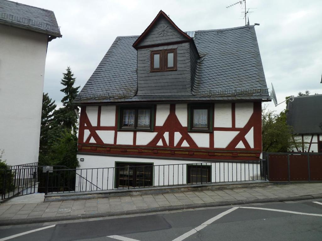 a red and white house with a black roof at Gästehaus Anja in Braunfels