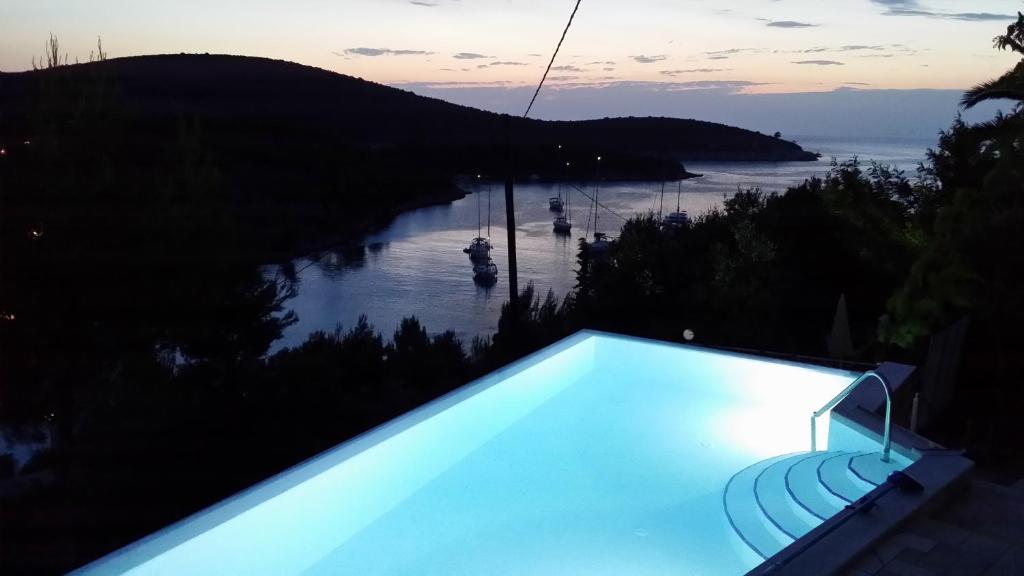 a swimming pool with a view of a river at Apartments Villa Sonia & Teo Hvar in Hvar