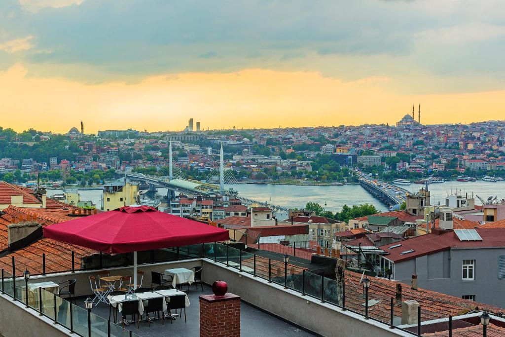 a building with a red roof with a view of a city at Meroddi Pera Flats in Istanbul