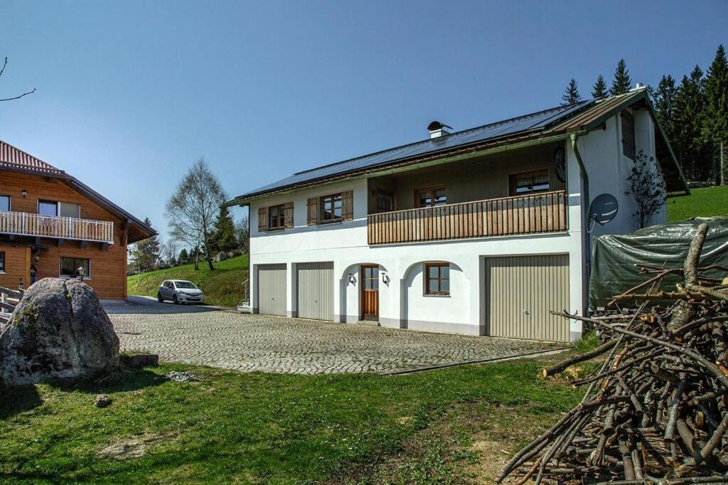 a large white house with a car parked in front of it at Panoramic view holiday home, Neureichenau in Neureichenau