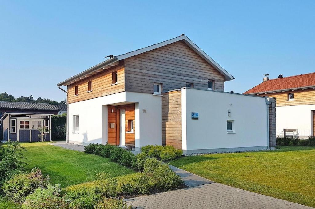 a large white house with a large garage at Vacation home Bel Ami, Nakenstorf in Nakensdorf