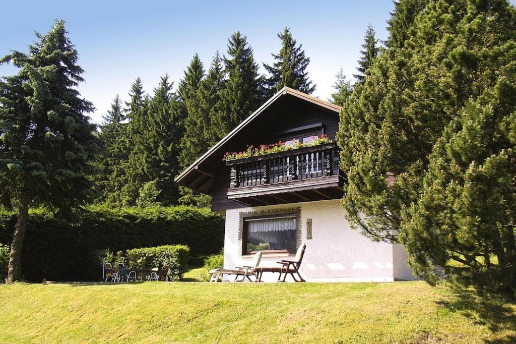 uma casa com uma varanda e uma mesa num quintal em Vacation Home, Oberschoenau em Oberschönau