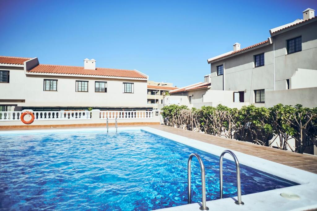 a swimming pool in front of a building at Luxury house in El Médano in El Médano