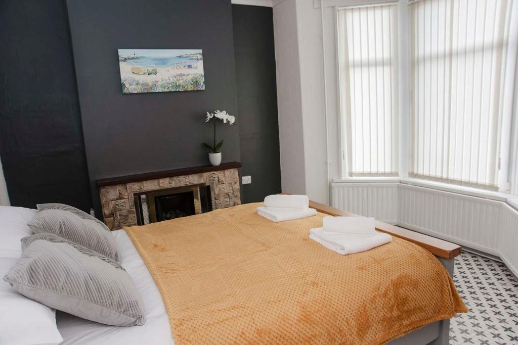 a bedroom with a bed with two towels on it at Six Bells Retreat in Abertillery