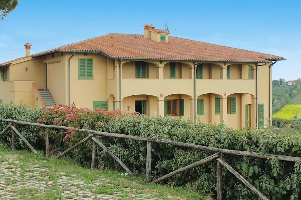 a house with a fence in front of it at Apartment in Cerreto Guidi in Cerreto Guidi