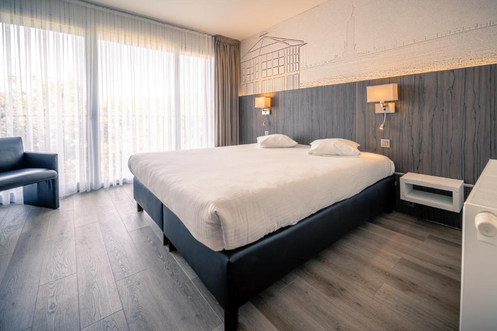 Postel nebo postele na pokoji v ubytování Hotel & Wellness Royal Astrid