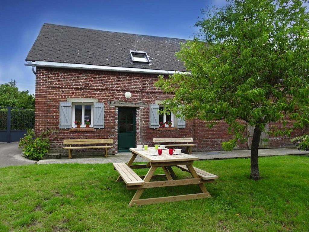 a picnic table in front of a brick house at Semi-detached house, Lancheres in Lanchères