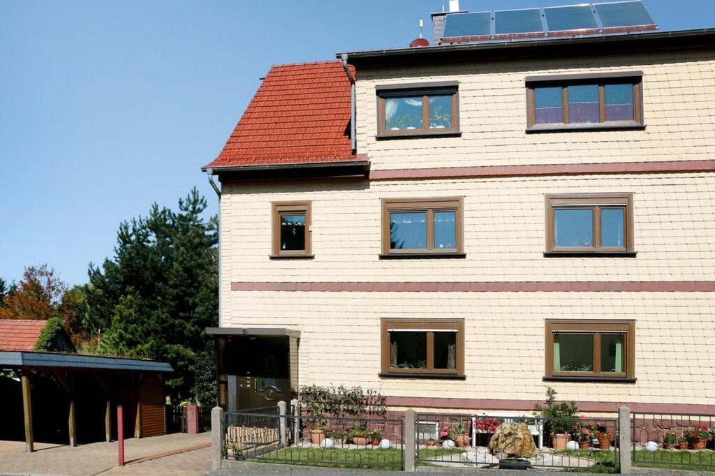 een groot wit gebouw met een rood dak bij Apartment, Tambach-Dietharz in Tambach-Dietharz