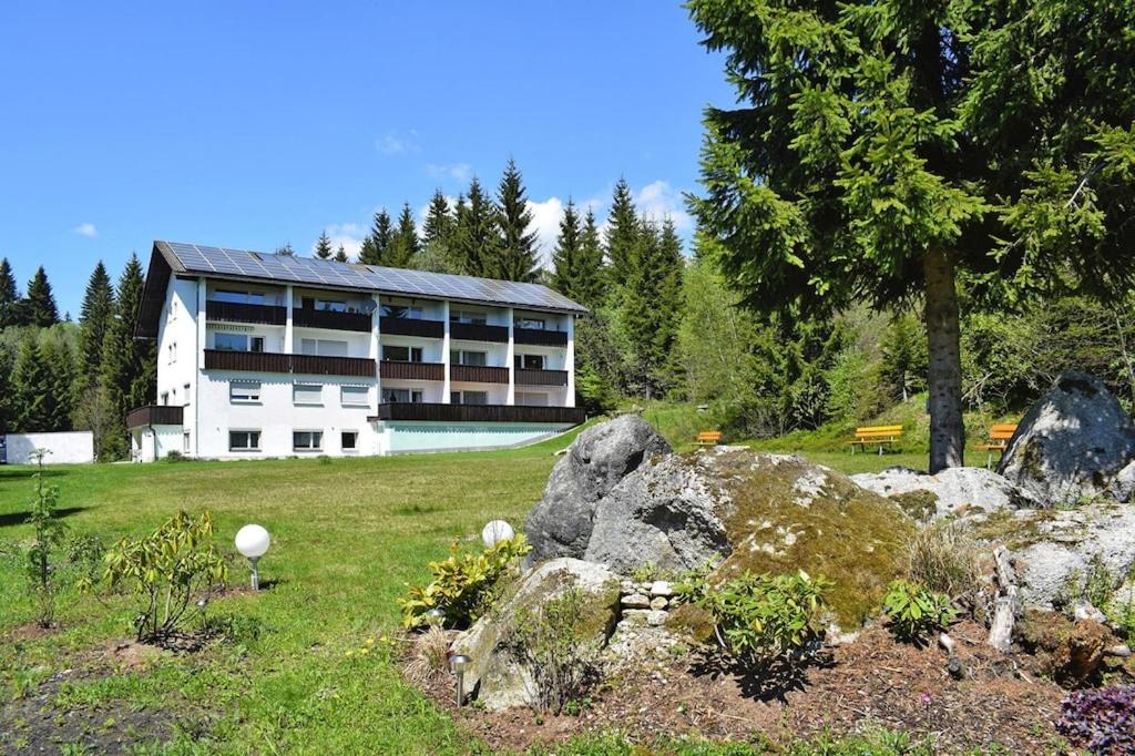 un grande edificio con un cortile con rocce di fronte di Apartment in Haidmühle in a beautiful area a Haidmühle