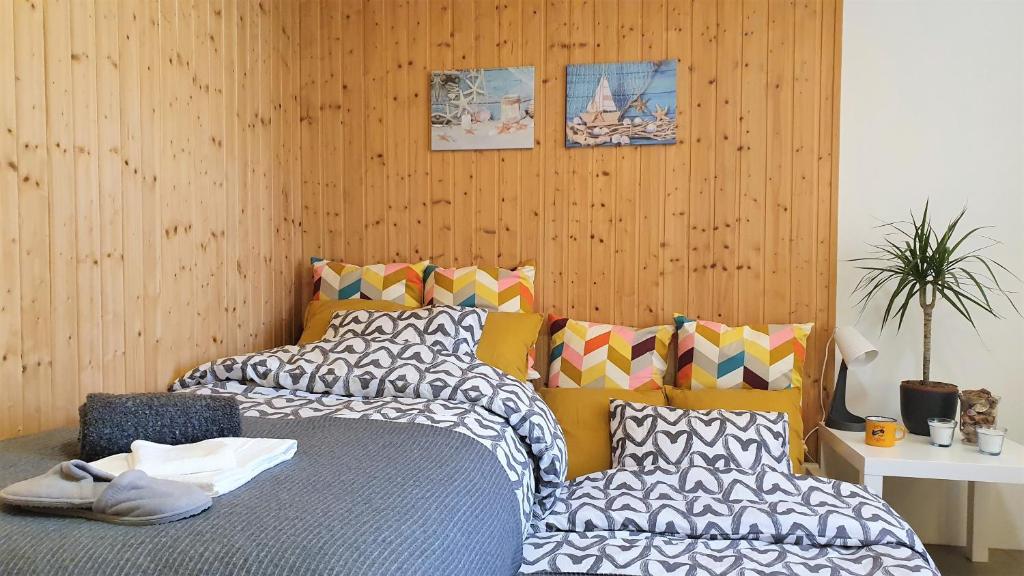 a bedroom with two beds and a wooden wall at Tapa Sauna House in Tapa