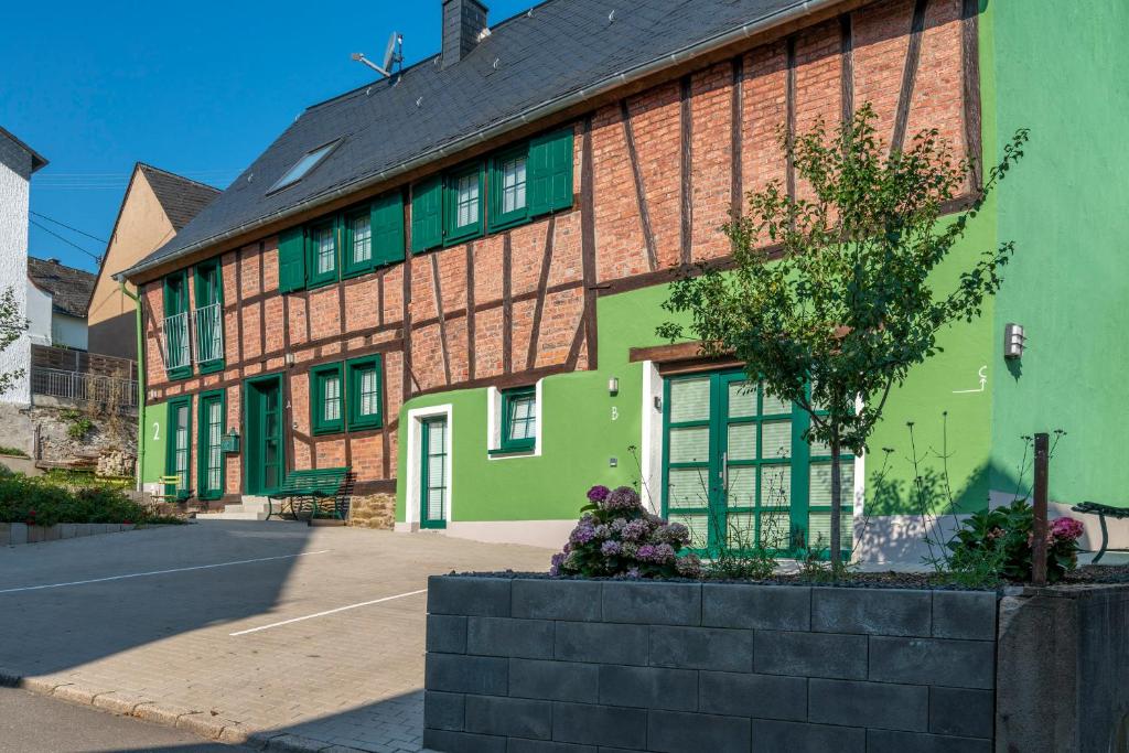 a large brick building with green and orange at Anduns exklusive Scheune in Boppard