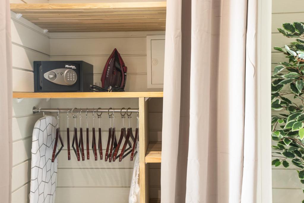 a closet with a shelf with utensils at Blue Sail Hotel in Anse Marcel 